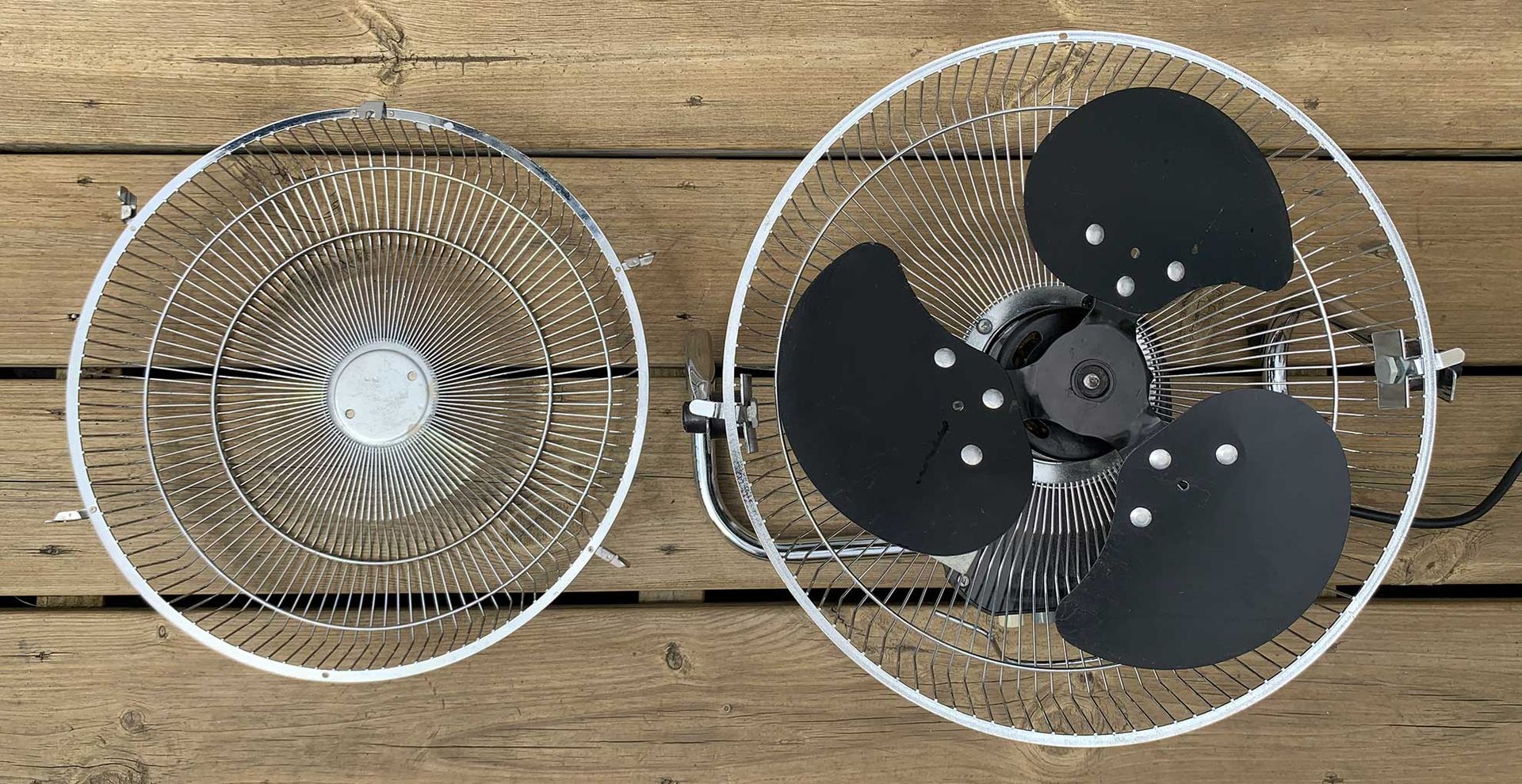 Oscillating fan with the guard removed to show the steps of how to clean a fan