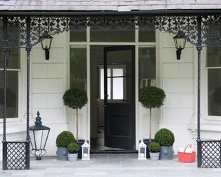 Front porch ideas showing a traditional English porch with black intricate metalwork
