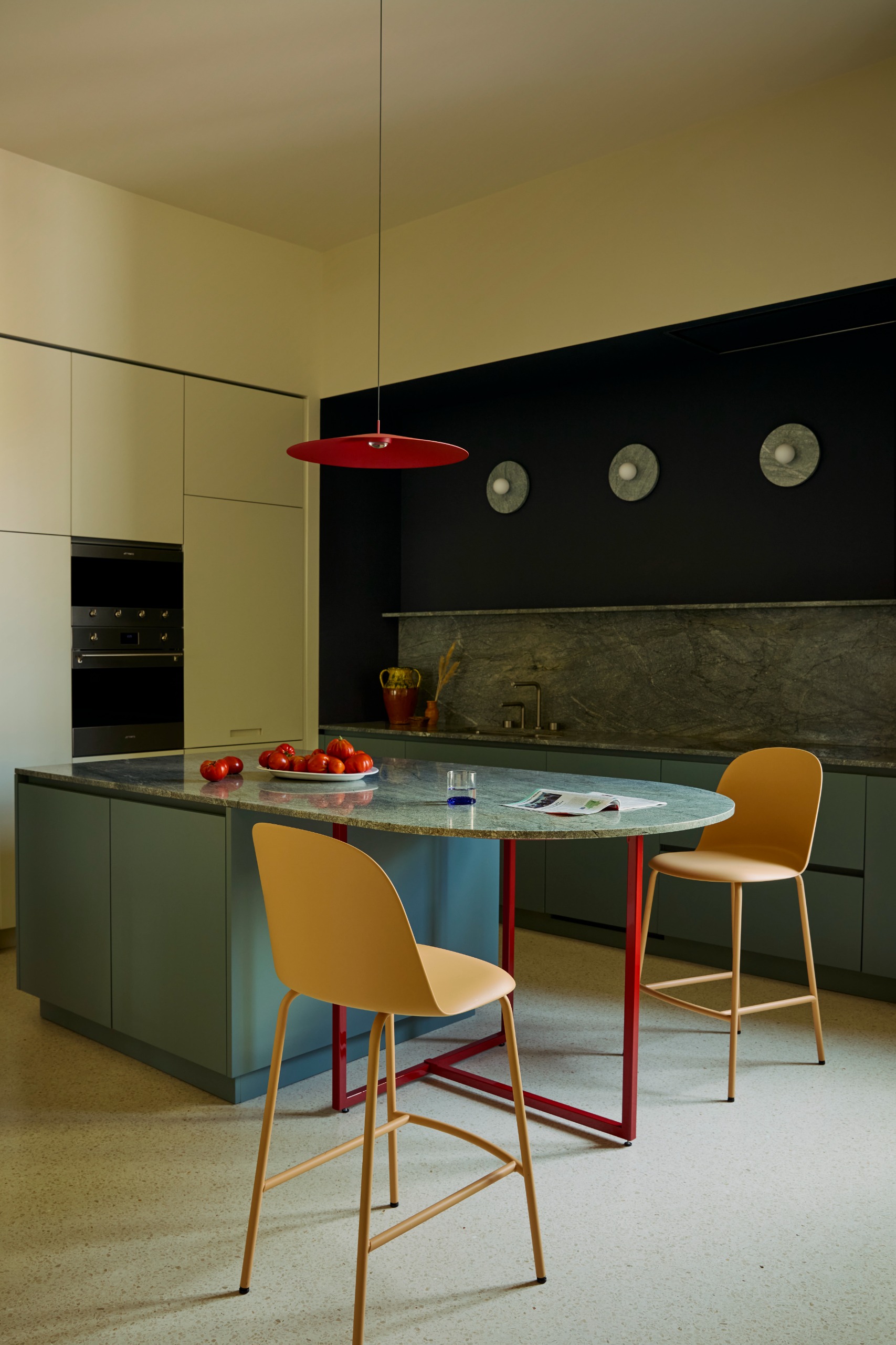 modern kitchen with blue cabinets and counters and red details