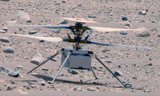 closeup of a small, four-rotor drone resting on the martian surface.