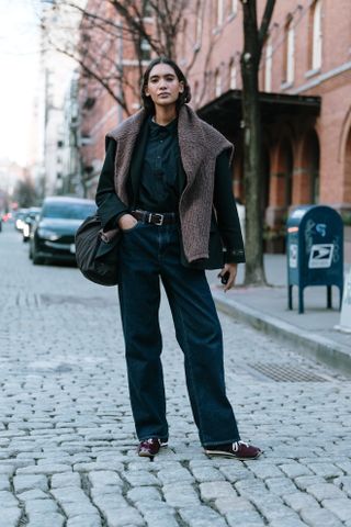 woman wearing button down shirt, jeans, cardigan, and sneakers