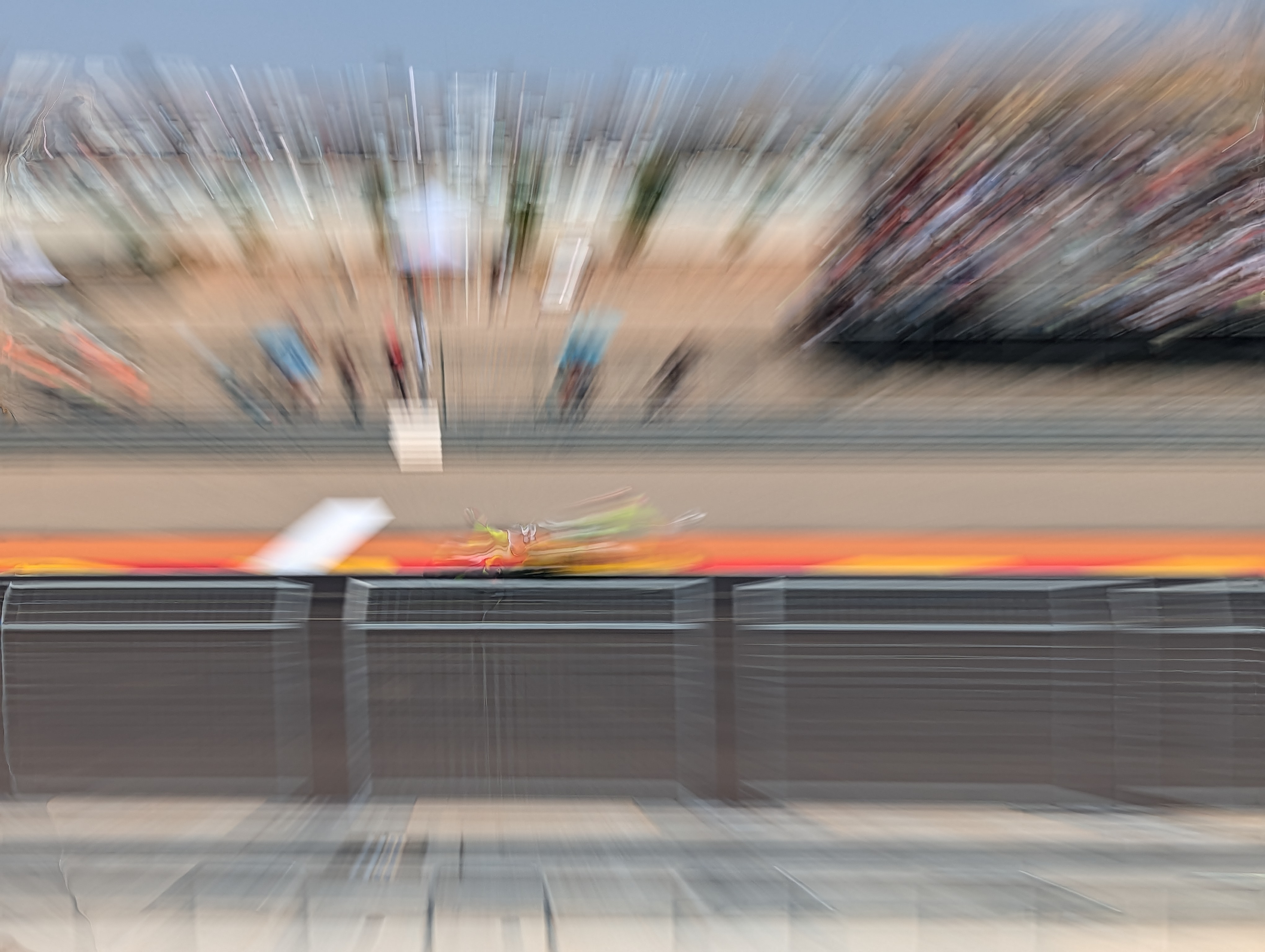 MotoGP riders at full speed on racetrack with action panning photography technique accentuating movement