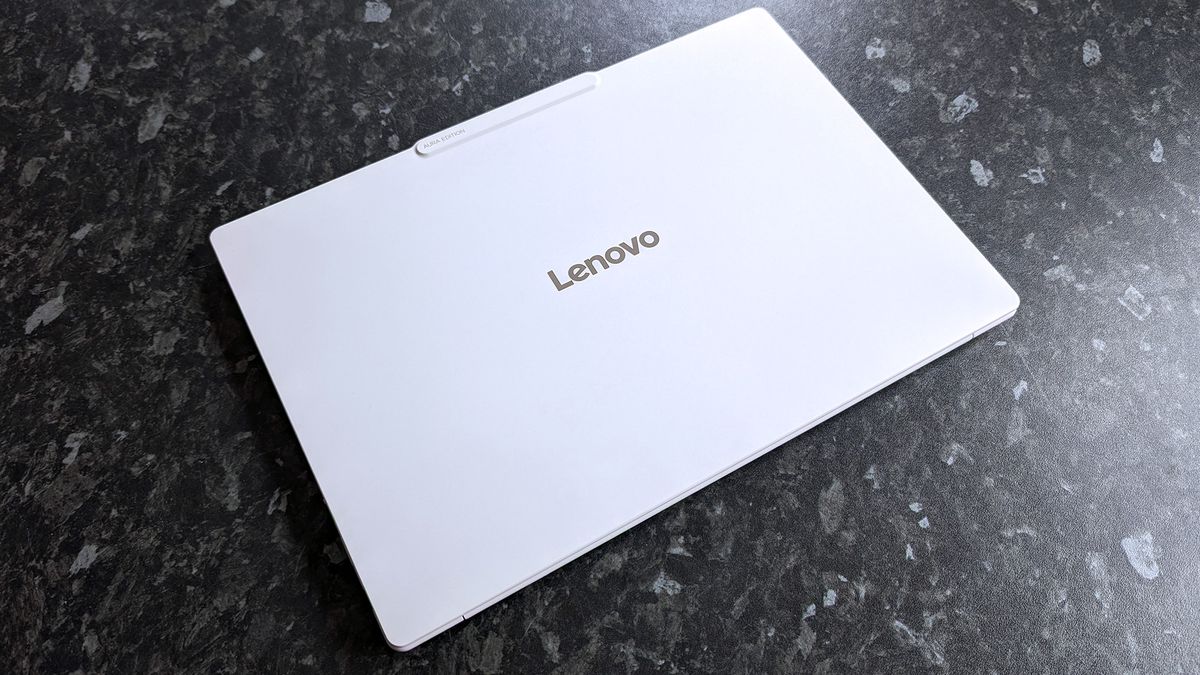 Closed Lenovo Yoga Slim 7i Ultra (Gen 11) Aura Edition laptop on a dark marbled surface. The Lenovo logo is centered on the lid.