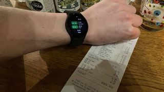 Samsung Galaxy Watch 4 being used to split a bill