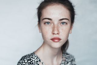 A young woman with freckles