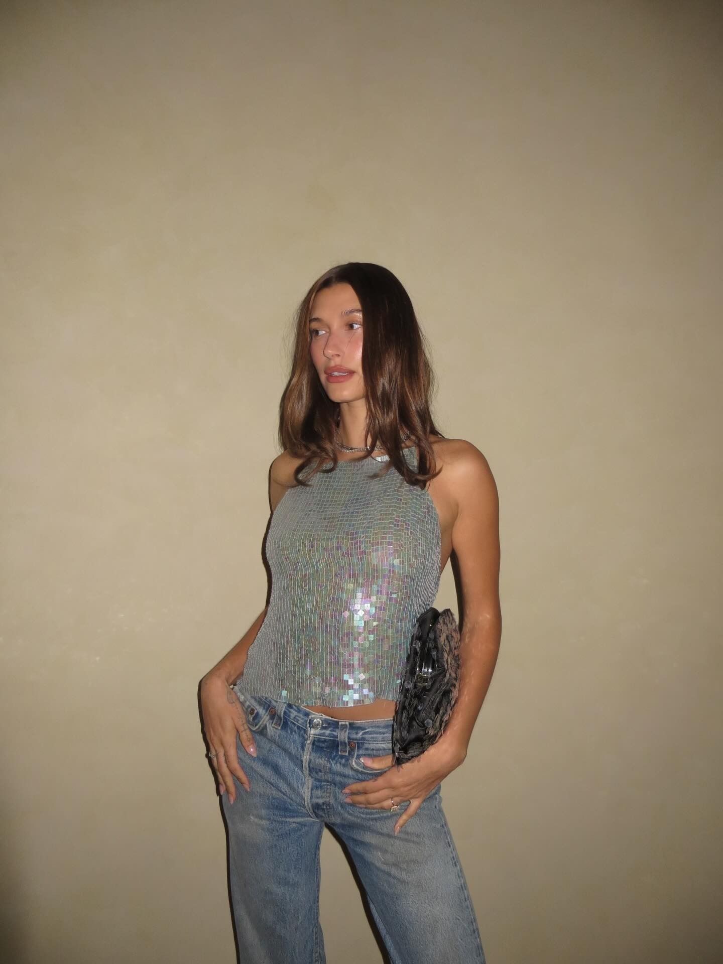 Hailey Bieber's 29th birthday outfit featuring a sequin top and Levi's 501 jeans.