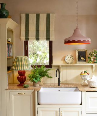 traditional kitchen with a Belfast sink, pendant light and table lamp on the worktop