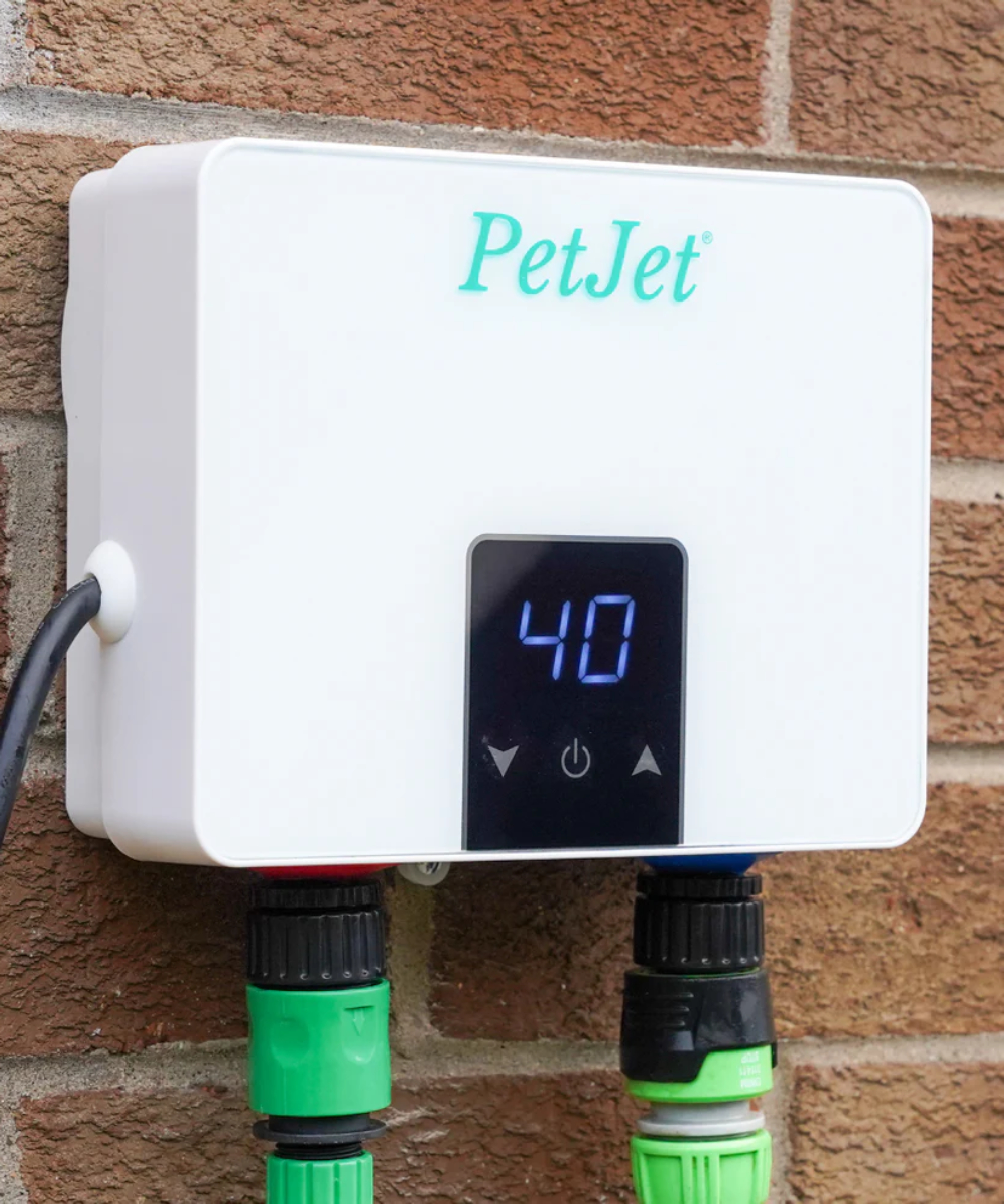 control panel connected to outdoor power source and hose showing temperature on front