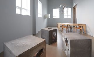 Concrete objects and wooden table and chairs