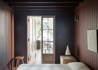 minimalist bedroom with dark walls