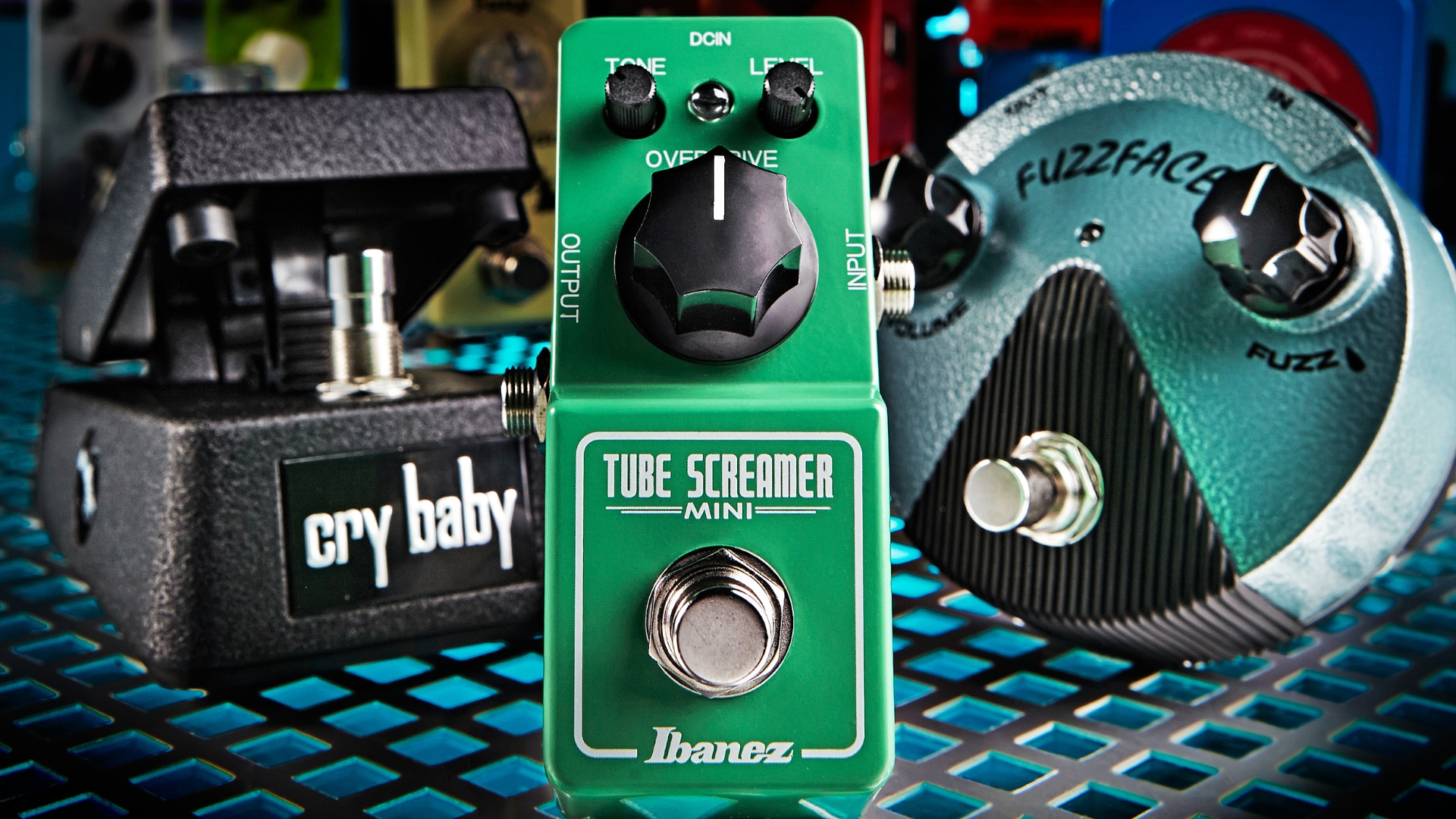 An Ibanez Tube Screamer Mini overdrive pedal with other guitar pedals in the background