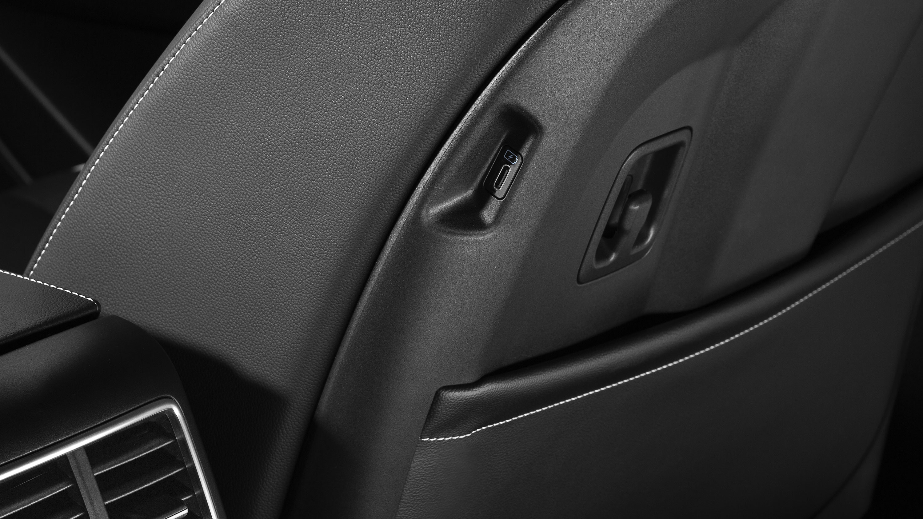 Close up of a USB port in the side of a car seat