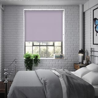 bedroom with white brick walls bed with white pillows and photoframe on wall
