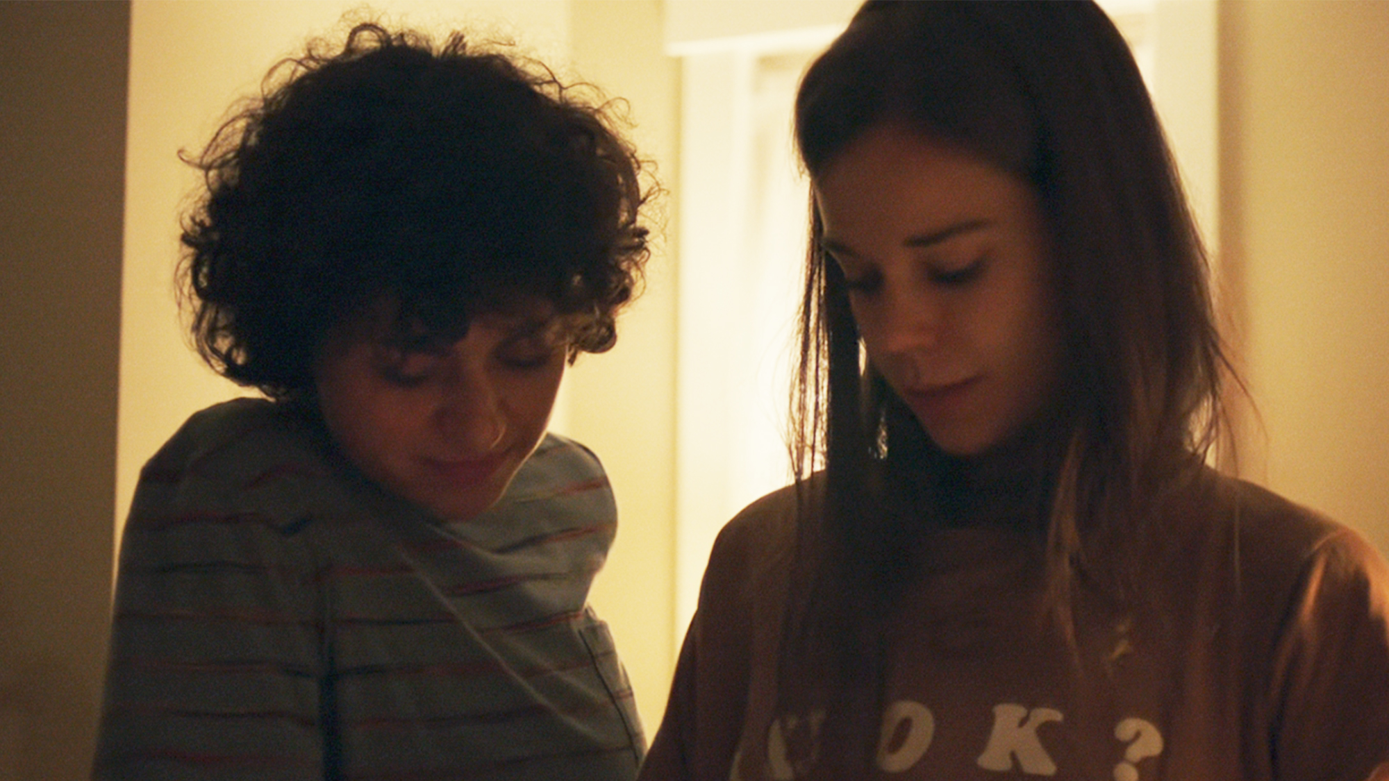 Two women looking down at something off camera in Duck Butter