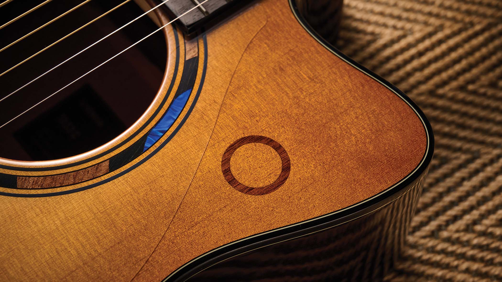 The Yamaha TransAcoustic TAG3 C is a cutaway acoustic guitar with a sandburst finished, photographed in closeup