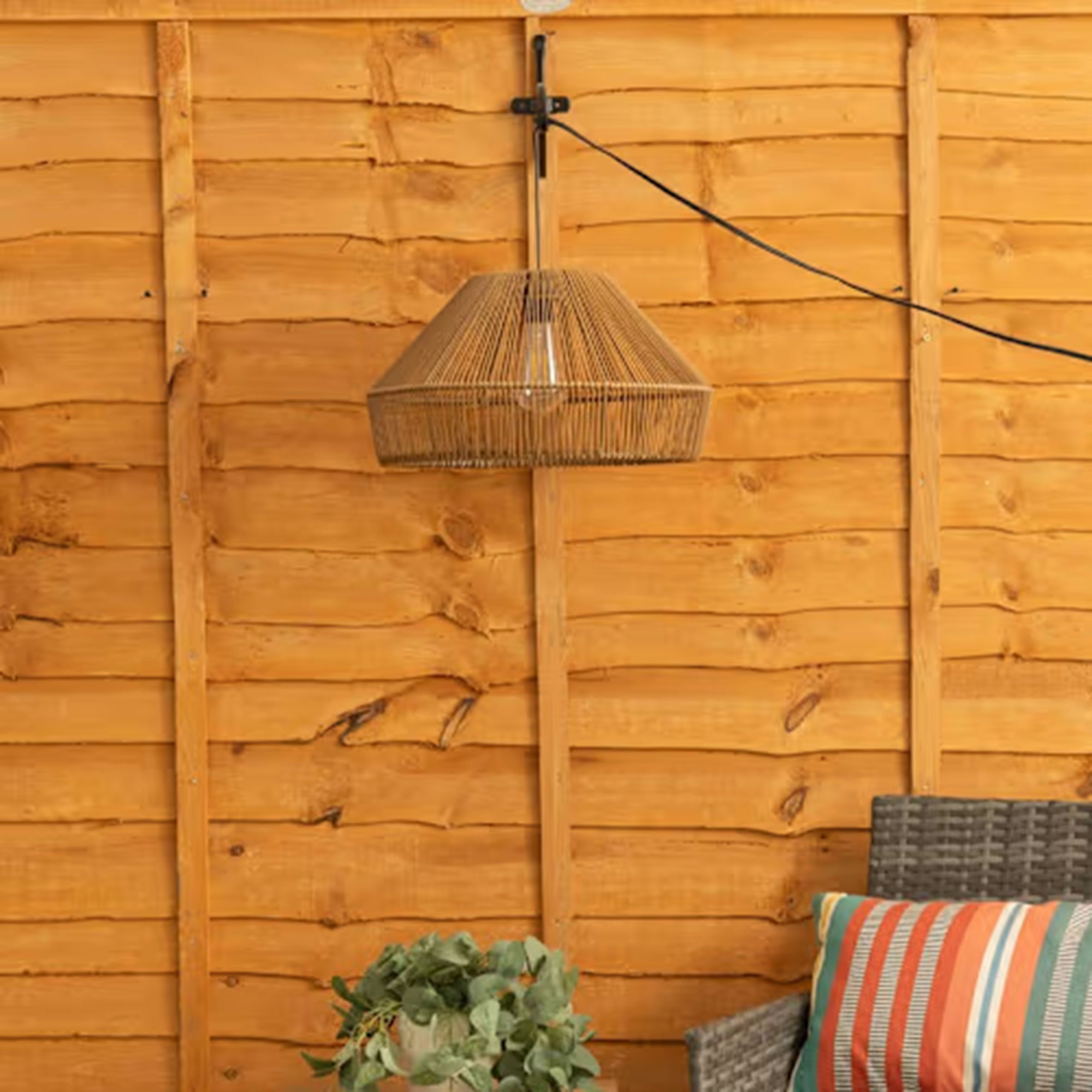 Rattan lamp attached to fence