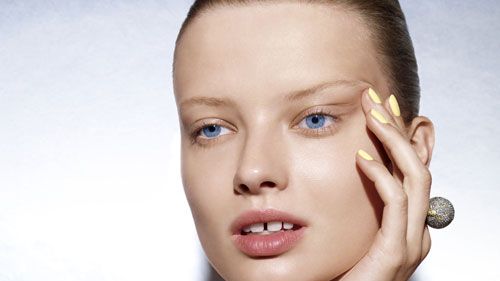 model holding her face
