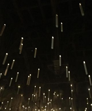 Floating candles against a black roof