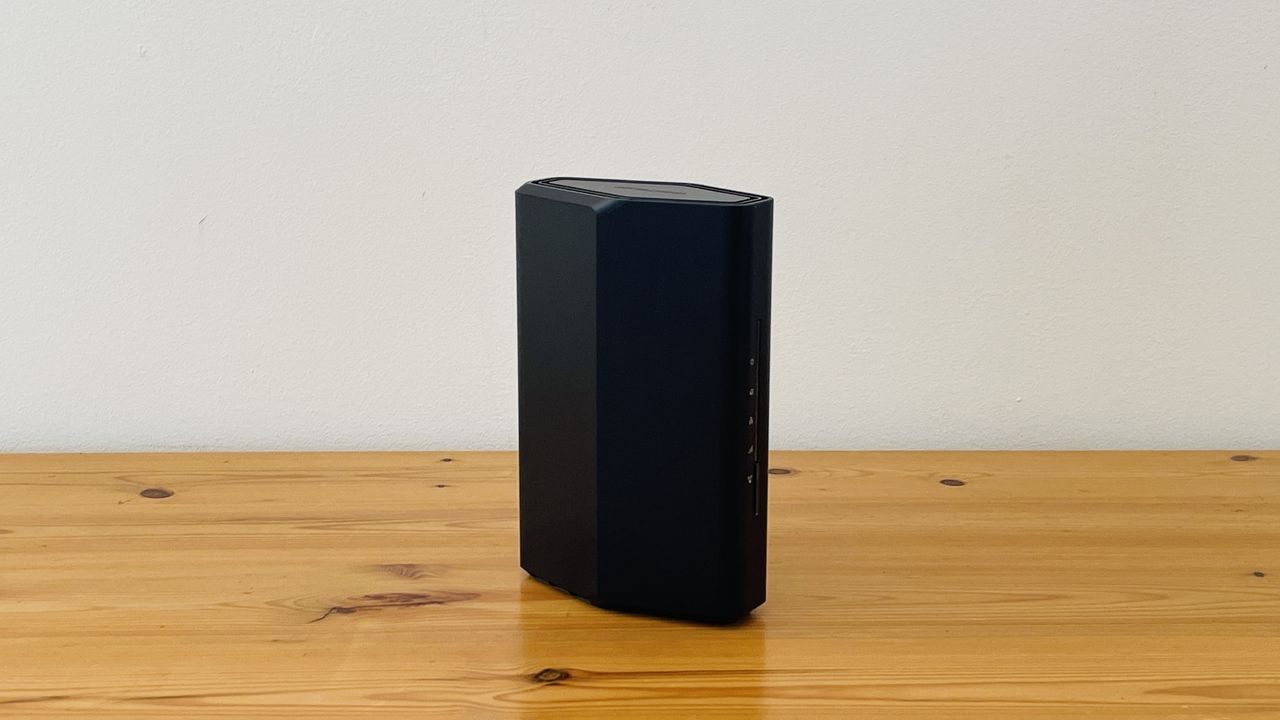 Netgear Nighthawk RS100 router on wooden table