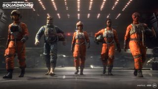 A team of Rebel pilots make their way through the hangar.