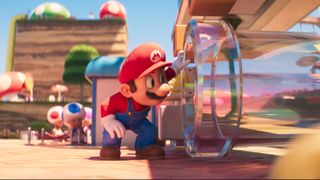 Mario (Chris Pratt) looks into a clear pipe in the Mushroom Kingdom in The Super Mario Bros. Movie.