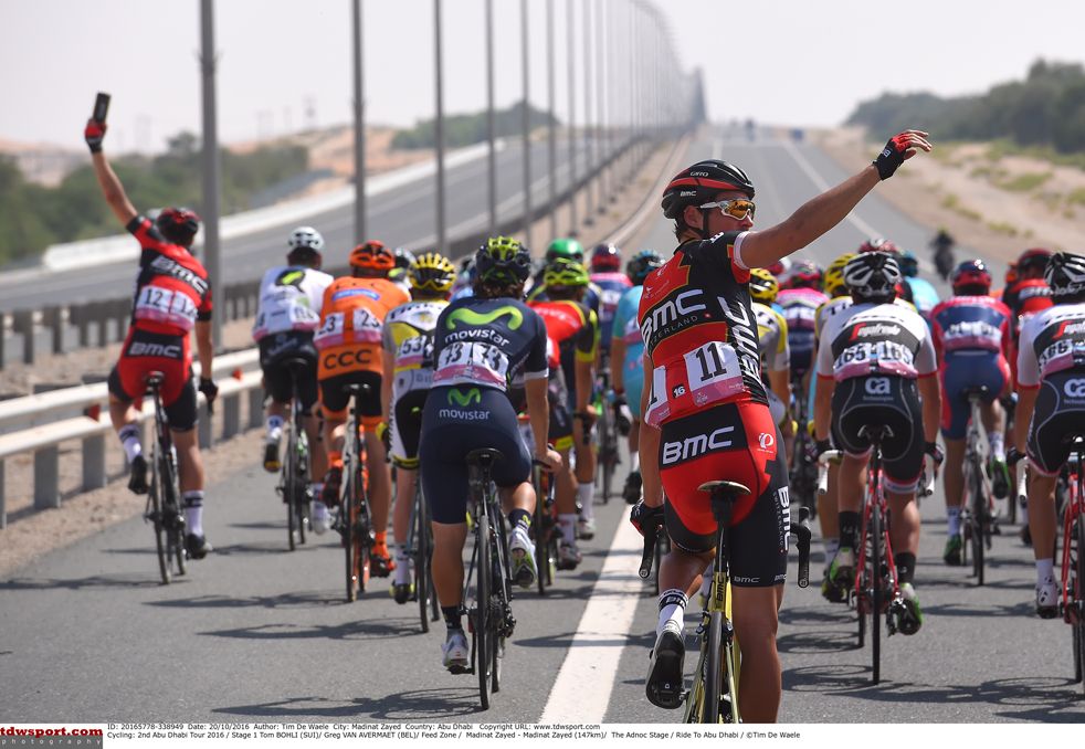 Riders call up their team cars at the Abu Dhabi Tour