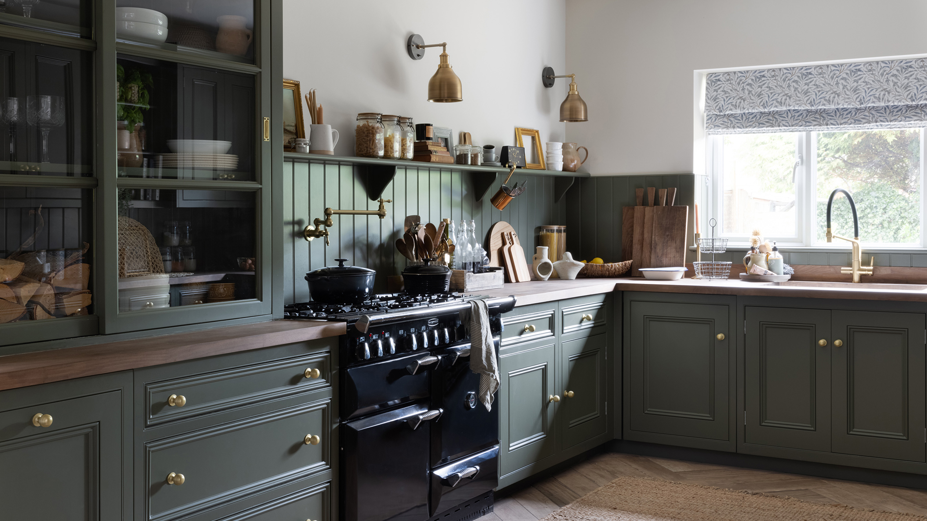 green second hand kitchen with black range cooker dresser and window with sink area Future PLC : Paul Craig