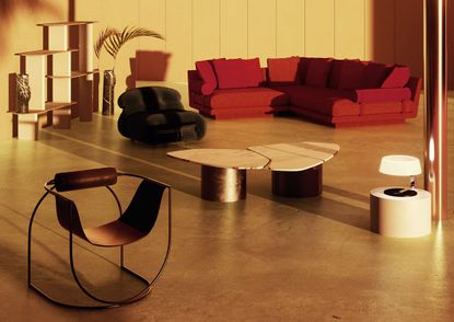 Living room vignette with red sofa, green velvet armchair and marble coffee table