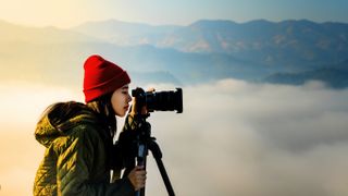 Female photographer with best travel tripod