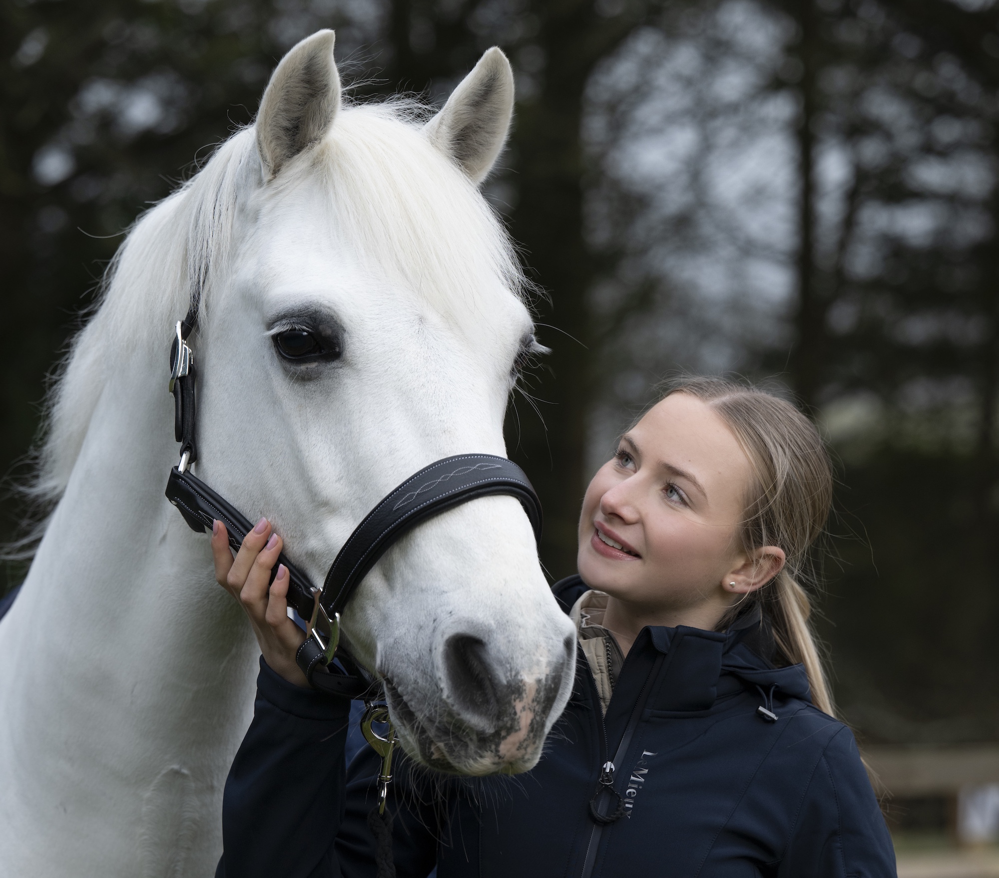 Headshot of Harlow White with her grey Connemara pony Panda