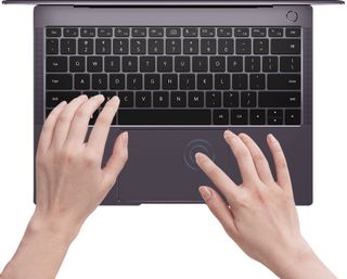 En person som sitter och skriver på en laptop. Visas mot en vit bakgrund.