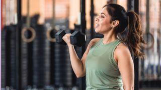 Woman lifting dumbbell in bicep curl