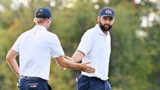 Scottie Scheffler low-fives Russell Henley in the Presidents Cup