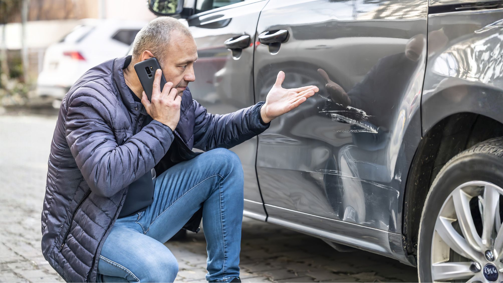A man on the phone reporting a car accident. 
