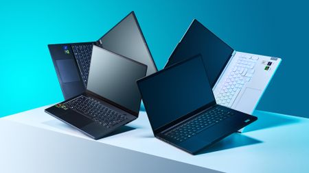 Four gaming laptops on a white plinth with a blue background.