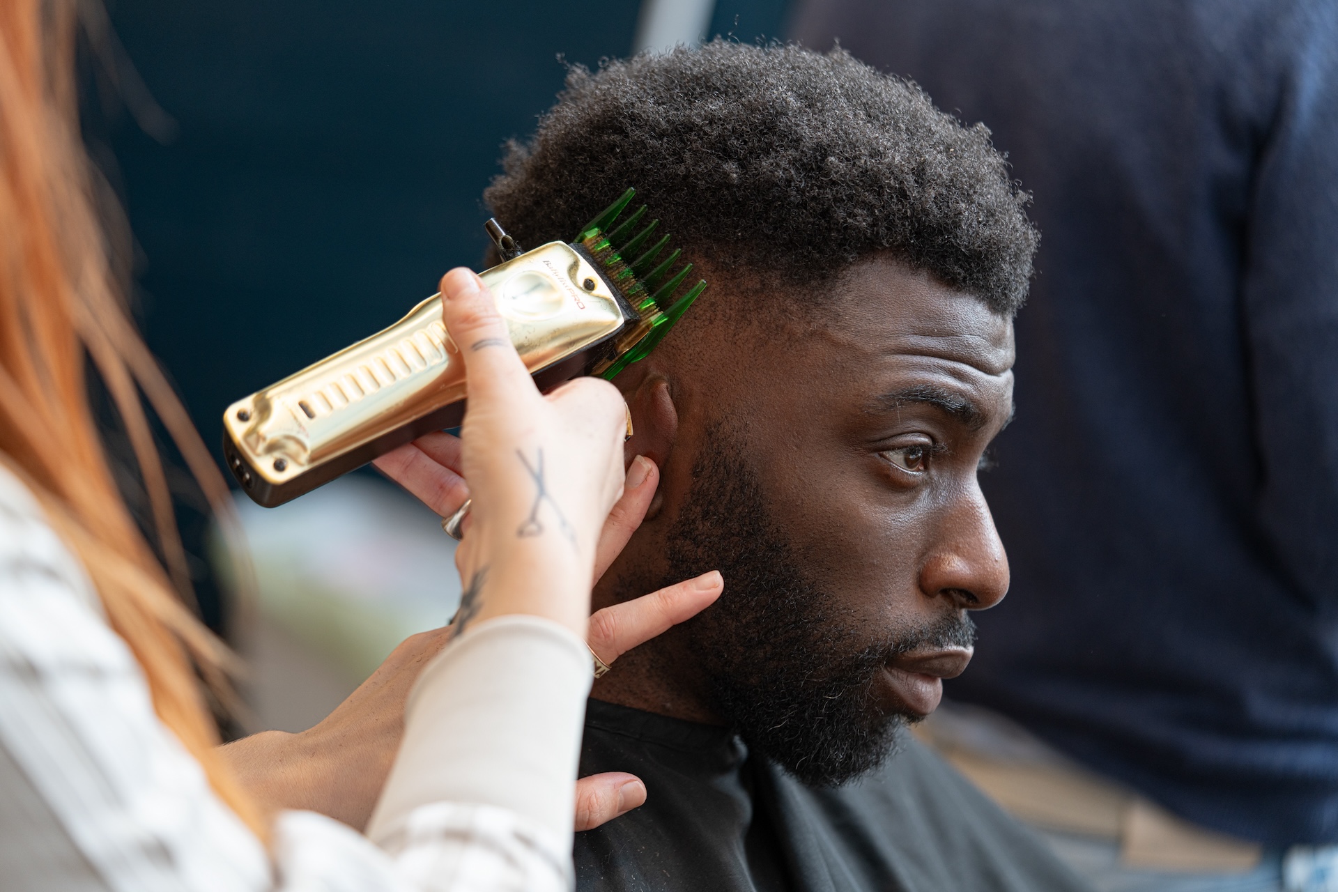 A man gets a trim at a barbers