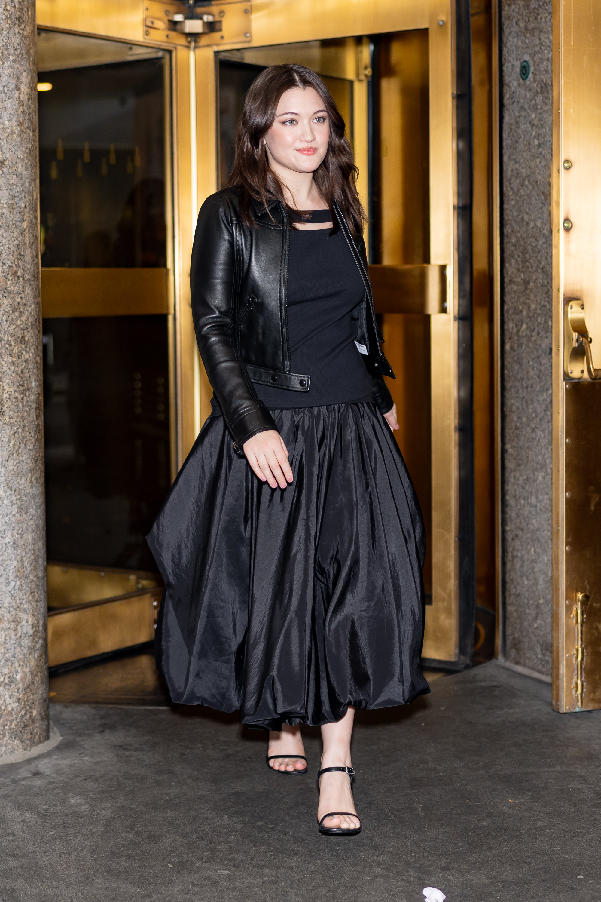 Isa Briones wore a black taffeta maxi skirt with a matching leather jacket in NYC
