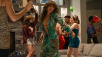 Allie dancing in a dress like JLo's green and blue dress in Off Campus. 