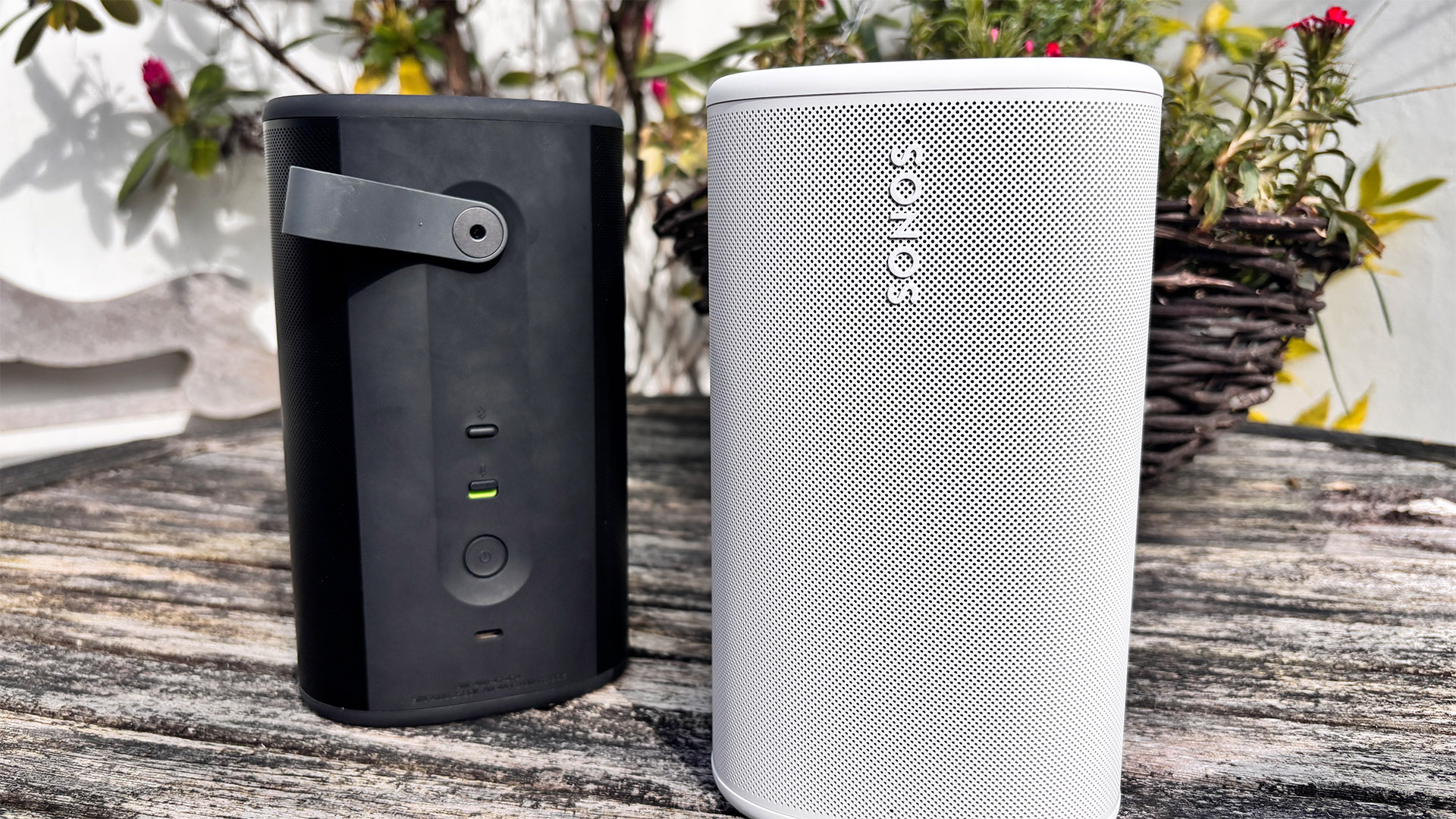 Sonos Play wireless speakers in black and white colourways in the garden
