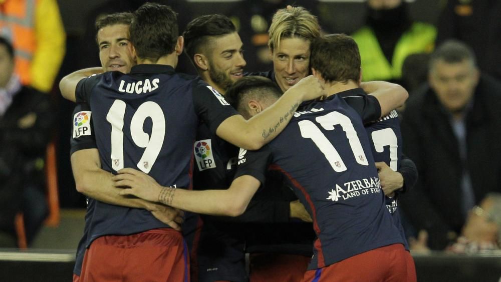 Valencia 1 Atletico Madrid 3: Torres and Carrasco keep title hopes