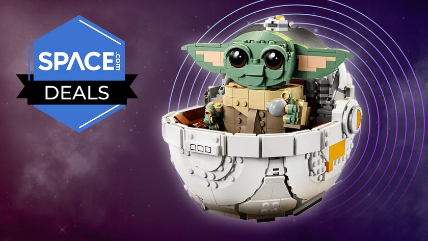 A Lego recreation of Grogu in his hover pram on a space background with a space.com deals badge in the top left corner