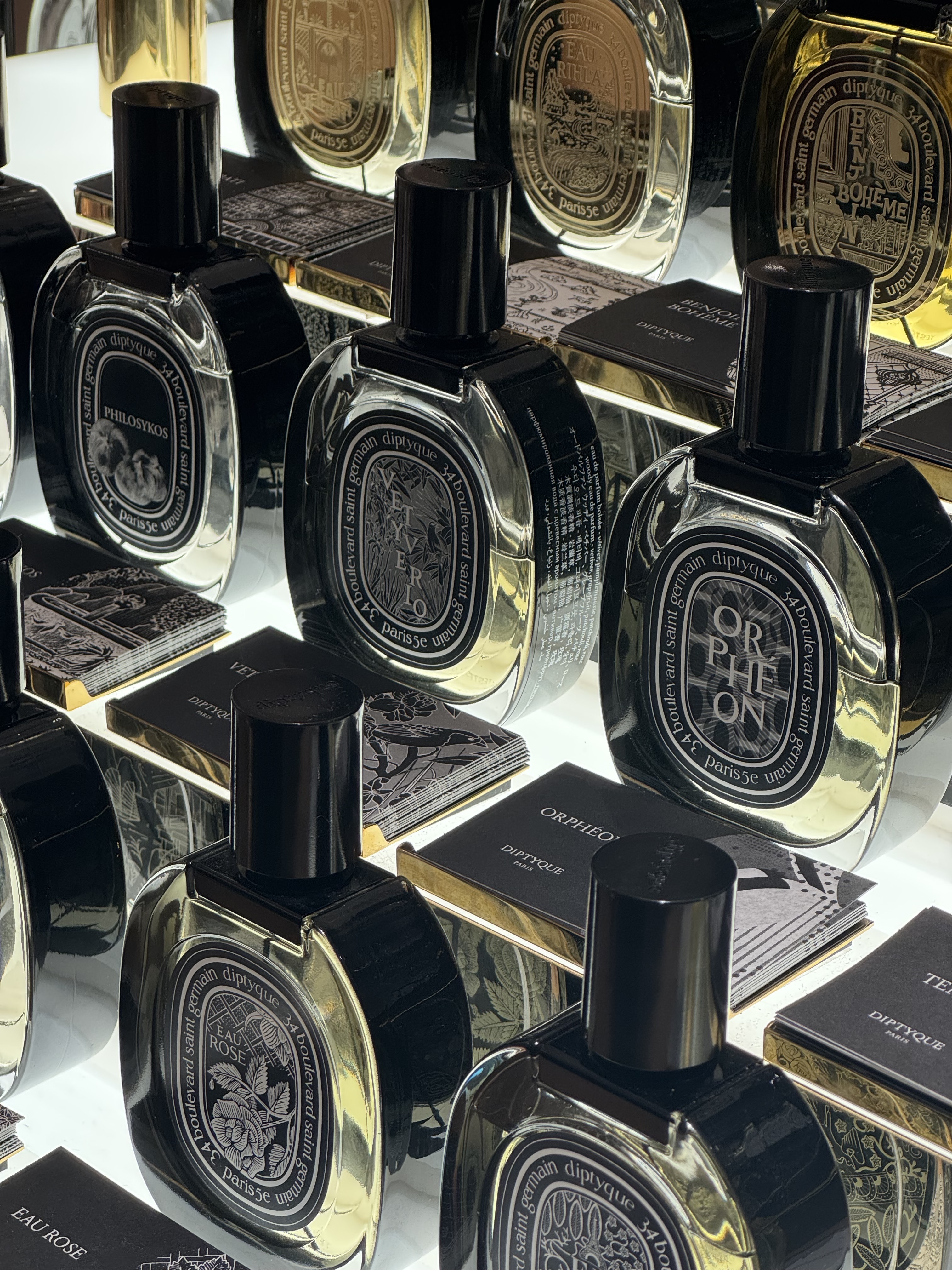 A close up of Diptyque eau de parfum perfume bottles