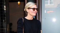 Kirsten Dunst wearing all black and sunglasses