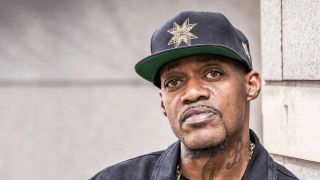 Eric Gales headshot, wearing a baseball cap