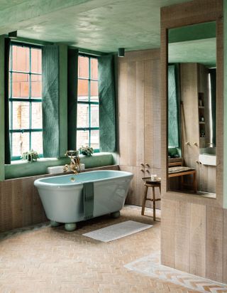 An example of bathroom wall ideas showing a bathroom with lime plastered walls and a green ceiling