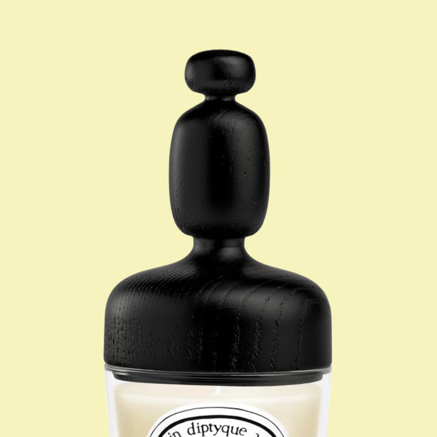 A structured black wood candle topper