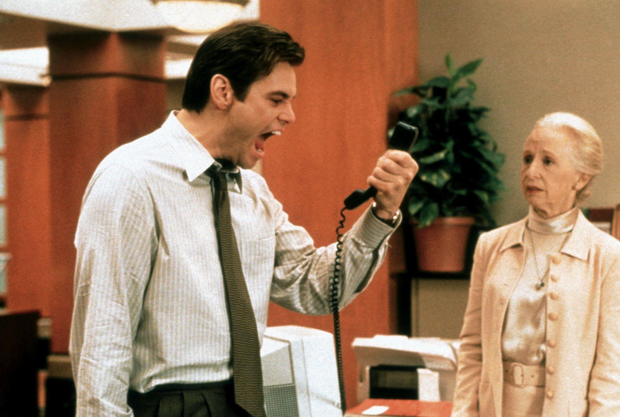 Jim Carrey wears professional cloths and screams into a phone in 'Liar Liar'