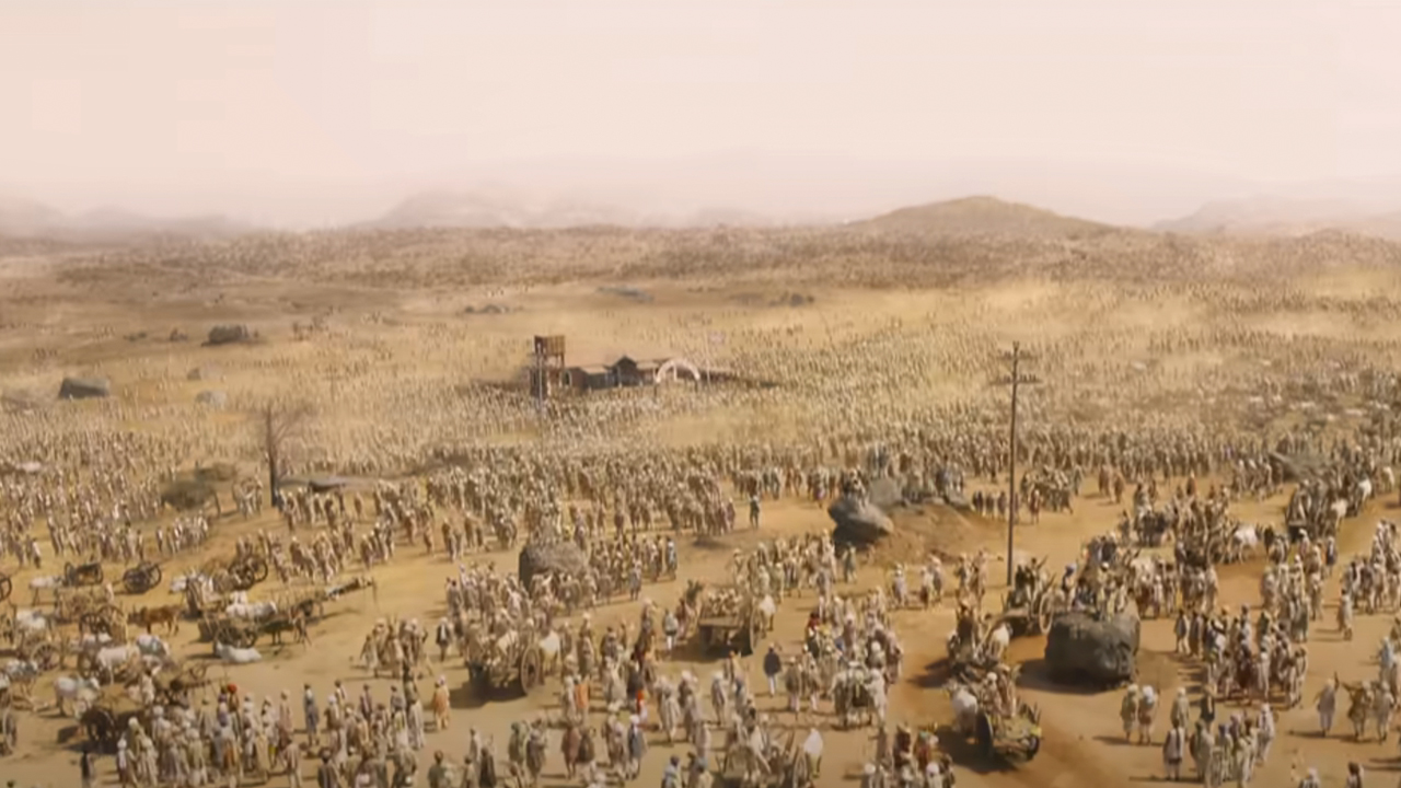 A huge panorama with thousands of people in a desert in RRR