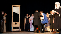 a guillotine displayed on stage in a theater