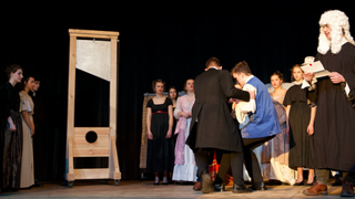 a guillotine displayed on stage in a theater